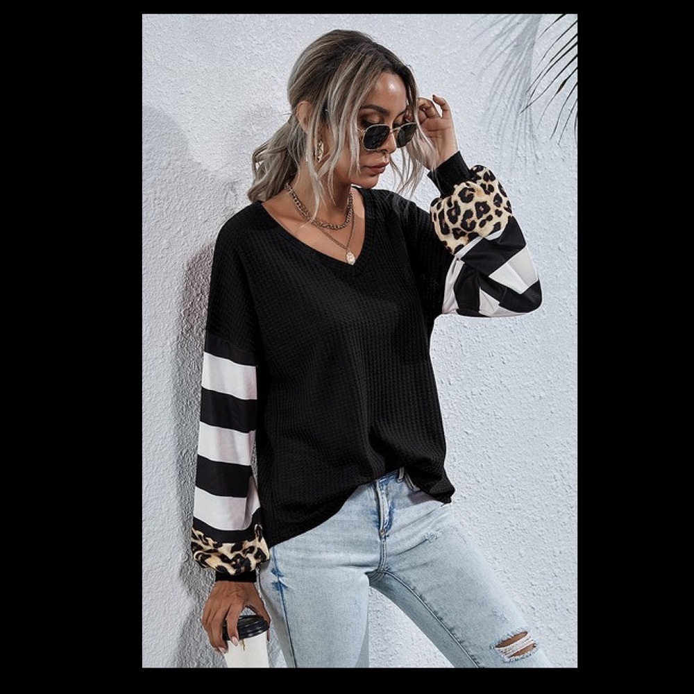 Black v neck solid and print puff sleeve top.